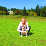 Donna and her puppy India, in a green grassy park